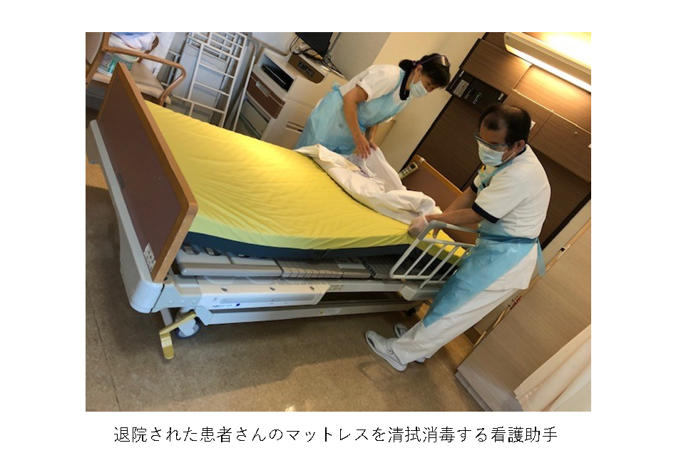 退院された患者さんのマットレスを清拭消毒する看護助手